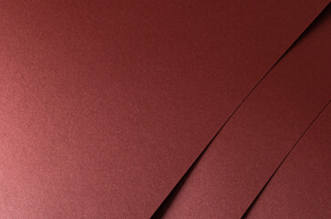 Burgundy red metallic satin paper texture with a pearlescent shimmer. The warm red-brown tones and subtle grainy texture create a sophisticated and refined design, ideal for luxury