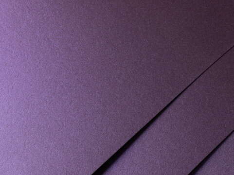 Deep purple paper texture with a pearlescent metallic finish, featuring sleek lines and a glowing gradient. The rich amethyst and lavender tones shimmer with light, creating an