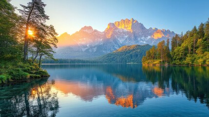 Fototapeta premium Majestic sunrise over alpine lake and mountain range.