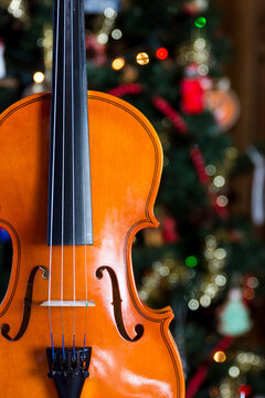 a violin wiht a christmas tree