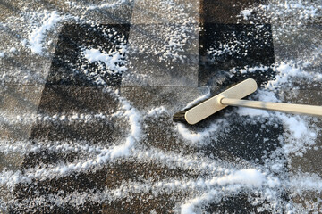 Cleaning rug carpet with foam cleaner using brush with long handle. Outdoor washing. 