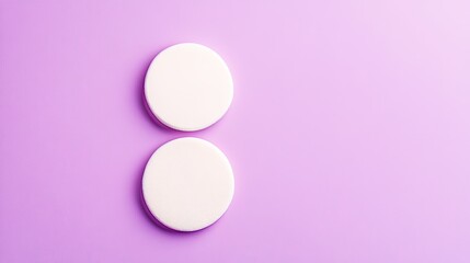 Obraz premium Minimalistic Composition Featuring Two Round White Foam Discs on a Soft Lavender Purple Background for Creative Design Purposes