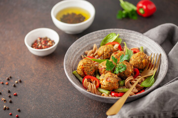 Vegan food. Vegetable meatballs and buckwheat pasta with vegetables in a bowl on the table.