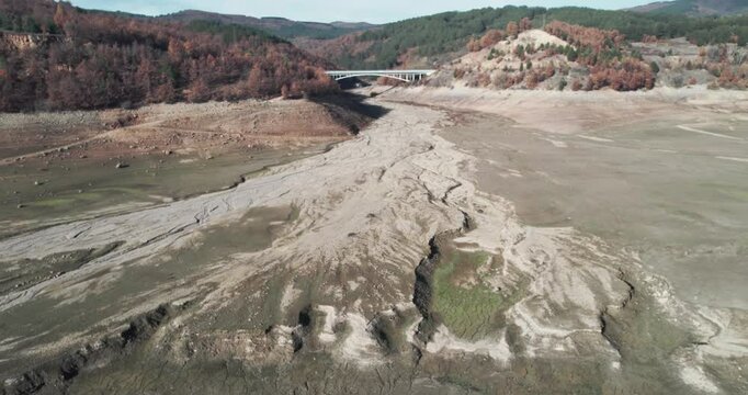 Dried lake and river in autumn because of agriculture irrigation, water crisis, climate change or drought concept.
