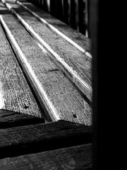 black and white old wooden floor of the bench in the park