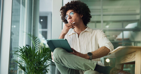 Thinking, tablet and creative man for planning, research project or email on internet. App designer, consultant and person on digital tech for problem solving, business social media or branding