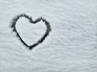 On the car window is a heart painted on fluffy snow. The concept of love, Valentine's Day, March 8th