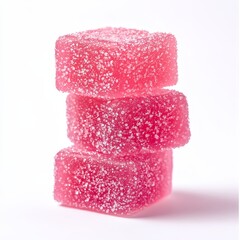 Three bright pink square jelly candies stacked on top of each other and sprinkled with sugar crystals on a white background.