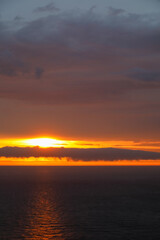 Cloudy sky over the Baltic Sea painted in the colours of the setting sun in Ustronie Morskie, West Pomerania, Poland