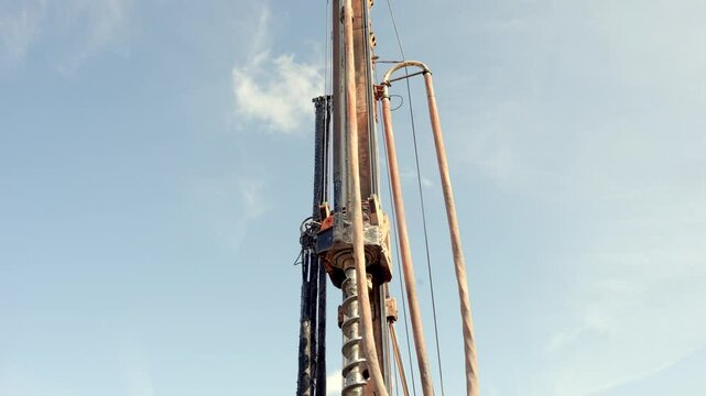 Drilling operation underway at a construction site with auger piling rig in use