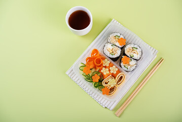 Bento box with sushi set with chicken filling and vegetables