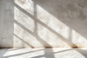 Sunlight streaming through window creating shadows on textured white wall