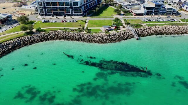 aerial drone shot of Coogee beach and Omeo shipwreck lying in tourquoise waters close to white sand beach of Fremantle, Western Australia, popular travel destination for snorkeling and scuba diving.
