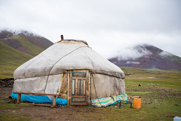 Mongolian local family live in the Ger between mountains and river, trees and lakes