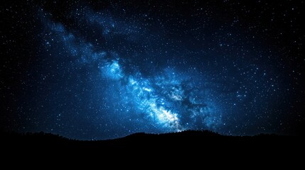 Vibrant Milky Way galaxy over silhouetted hills.