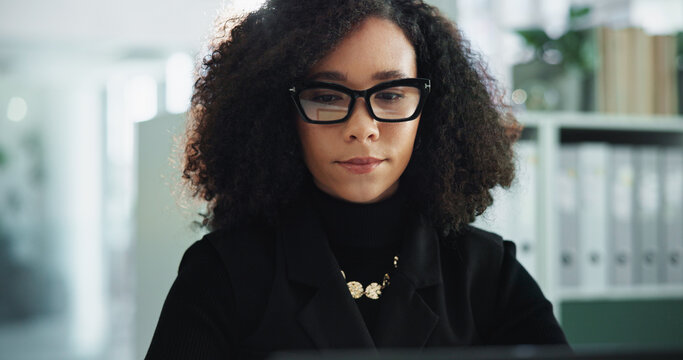 Business woman, glasses and serious in office with deadline, financial report and accountant. Female person, employee and typing for auditing or update company payroll, pay slip and bookkeeping