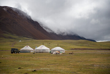 Mongolian local family live in the Ger between mountains and river, trees and lakes