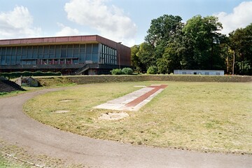 building of Mestske lazne and old stadium in Chomutov in Czechia on 10. September 2024 on color film - blurriness and noise of scanned 35mm film were intentionally left in image