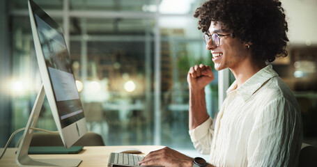 Man, computer and office night for celebration, fist pump and promotion success or achievement. Male person, salary increase and reading news of bonus at workplace, excited employee and sales goals © HockleyM2/peopleimages.com