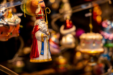Christmas decorations colorful balls and toys, fir tree branches and cones, lanterns, small angel and Santa figures. Christmas market fair in Europe. Preparation for celebration of xmas and New Year
