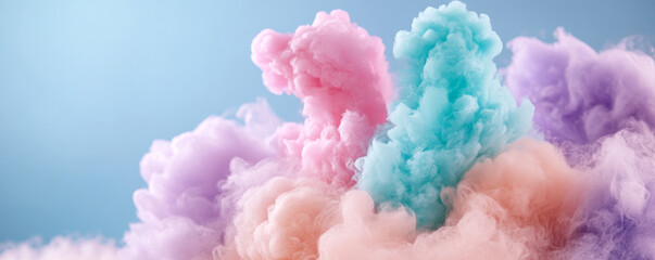 Fototapeta premium Fluffy pastel clouds in pink, blue, and purple create dreamy atmosphere