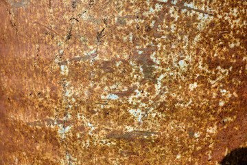 Close up of the external surface of a rusty oil barrel
