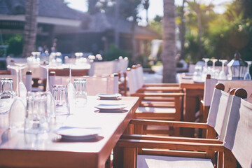 Relaxing Outdoor Dining Area with Empty Tables in Sunlight