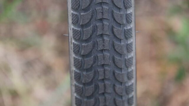 Close-up of a bicycle tire showing tread pattern details.