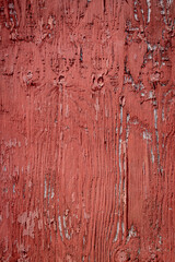 Texture of red barn wall with peeling paint