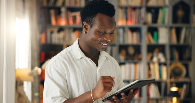Library, student and black man with tablet for education, college website and check results for exam. Home, happy person and reading with digital for university research, test information or learning
