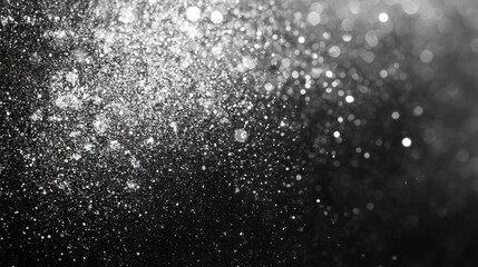 Abstract silver glitter bokeh on black background