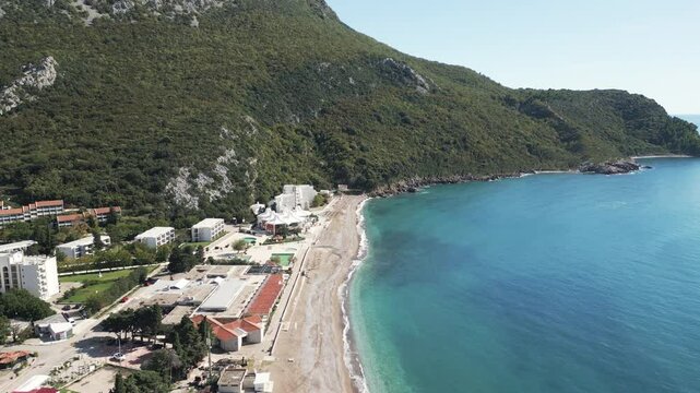 Aerial video of golden beaches meet turquoise Adriatic sea in town of Canj, Montenegro