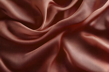 Fototapeta premium Elegant smooth brown satin fabric with rich texture and flowing drapes in color of the year 2025 mocha mousse