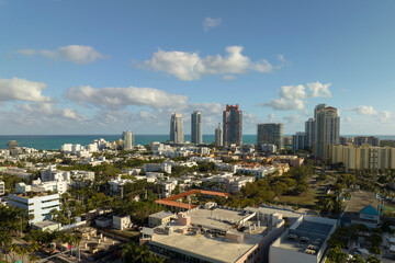 Obraz premium Aerial view of South Beach sandy surface with tourists relaxing on hot Florida sun. Miami Beach city with high luxury hotels and condos. Tourism infrastructure in southern USA