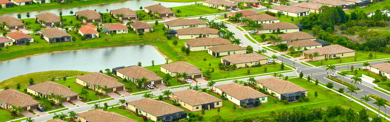 Aerial view of tightly located family houses in Florida closed suburban area. Real estate development in american suburbs