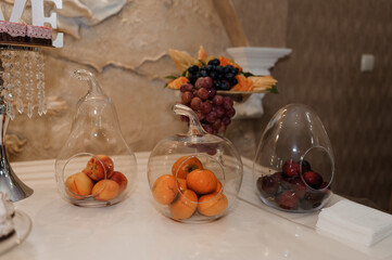 Elegant Fruit Display in Glass Containers at a Festive Event