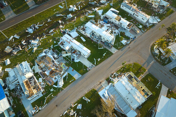 Fototapeta na wymiar Destroyed by hurricane Ian suburban houses in Florida mobile home residential area. Consequences of natural disaster