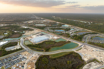 Fototapeta premium Development of residential housing in the USA. Wooden frames of new cheap American homes under construction