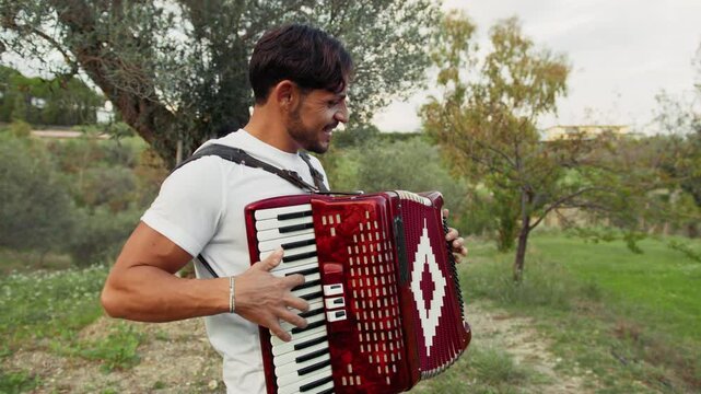 Smling Player Of Accordion Having Fun in The Countryside