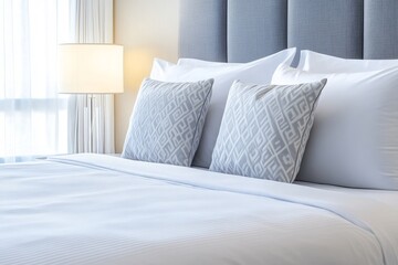 Comfortable hotel room with perfectly made bed and decorative pillows
