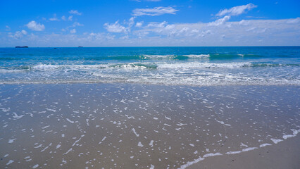 Natural Scenery Of Tropical Beach With Crystal Clear Water With Sky Decorated With Fluffy White Clouds On A Clear Blue Canvas