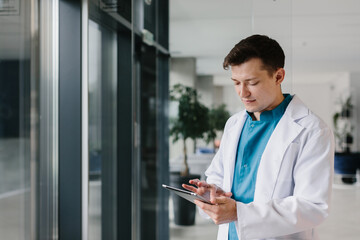 Healthcare professional with a digital tablet reviewing medical data.