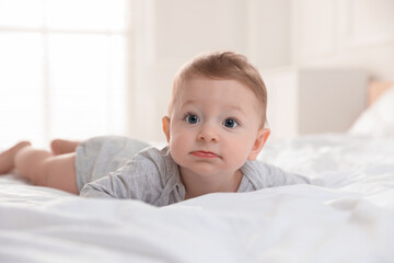 Cute little baby on bed at home