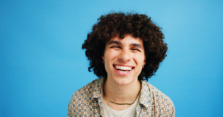 Happy man, portrait and student in studio with fashion, funny joke and excited at space. Person,...