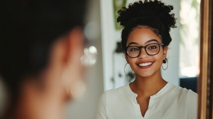 Happy woman looking at her reflection in a mirror, smiling.