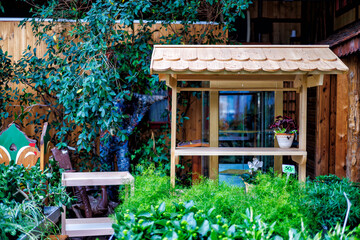 The interior of a flower shop with shelves and racks and plants on them.