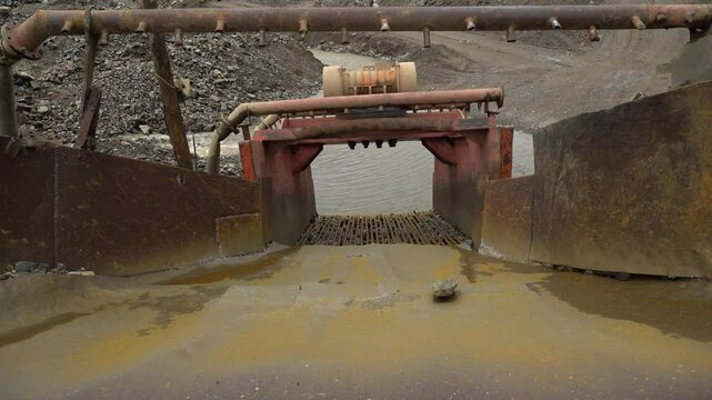 Placer gold mining in Russia. Ecological disaster. Dredge for processing soil and searching for gold.