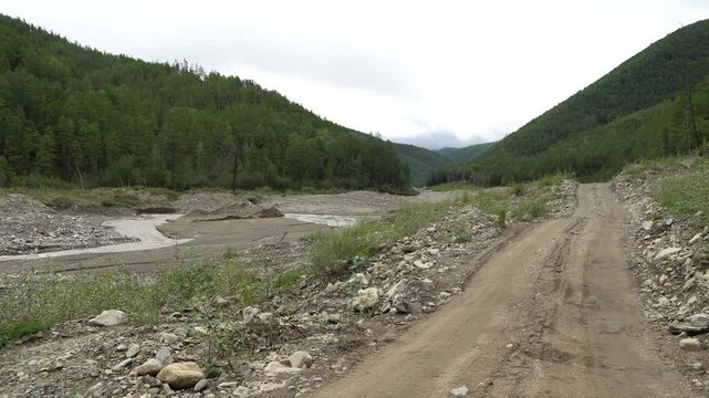 Placer gold mining in Russia. Ecological disaster. Dirty process water from gold washing in a river.