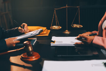 Judge gavel with Justice lawyers having team meeting at law firm background. Concepts of Law and...