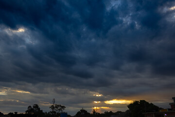 Silhouette of electric wires in the evening sky with rays of light.